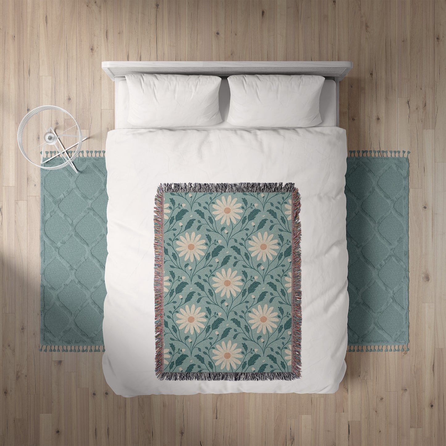 Bed with white bedding and a floral throw blanket