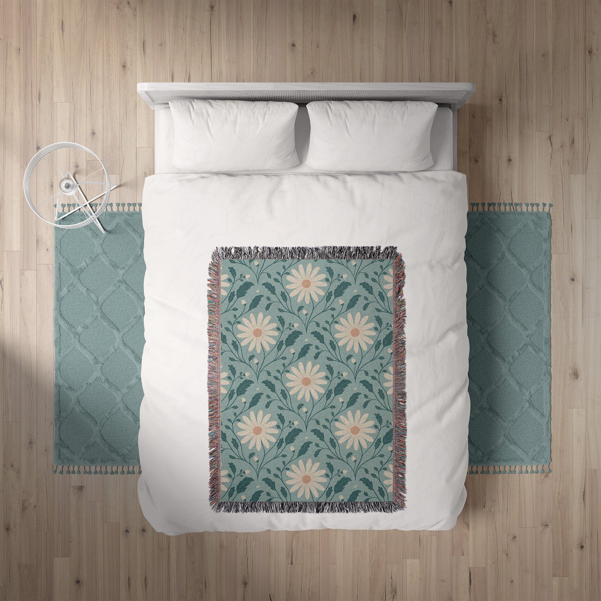 Bed with white bedding and a floral throw blanket