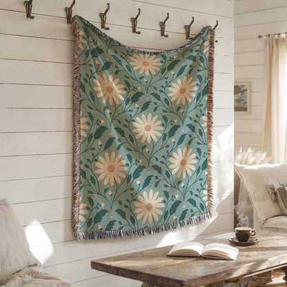 Floral patterned throw blanket hanging on a wall with a cozy living room setting.