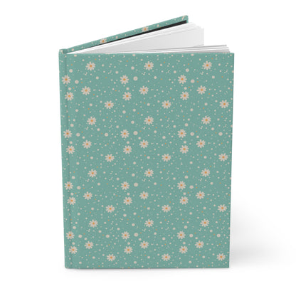 Notebook with a floral pattern on a teal background