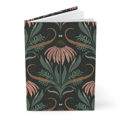 Notebook with floral and leaf pattern on a dark background