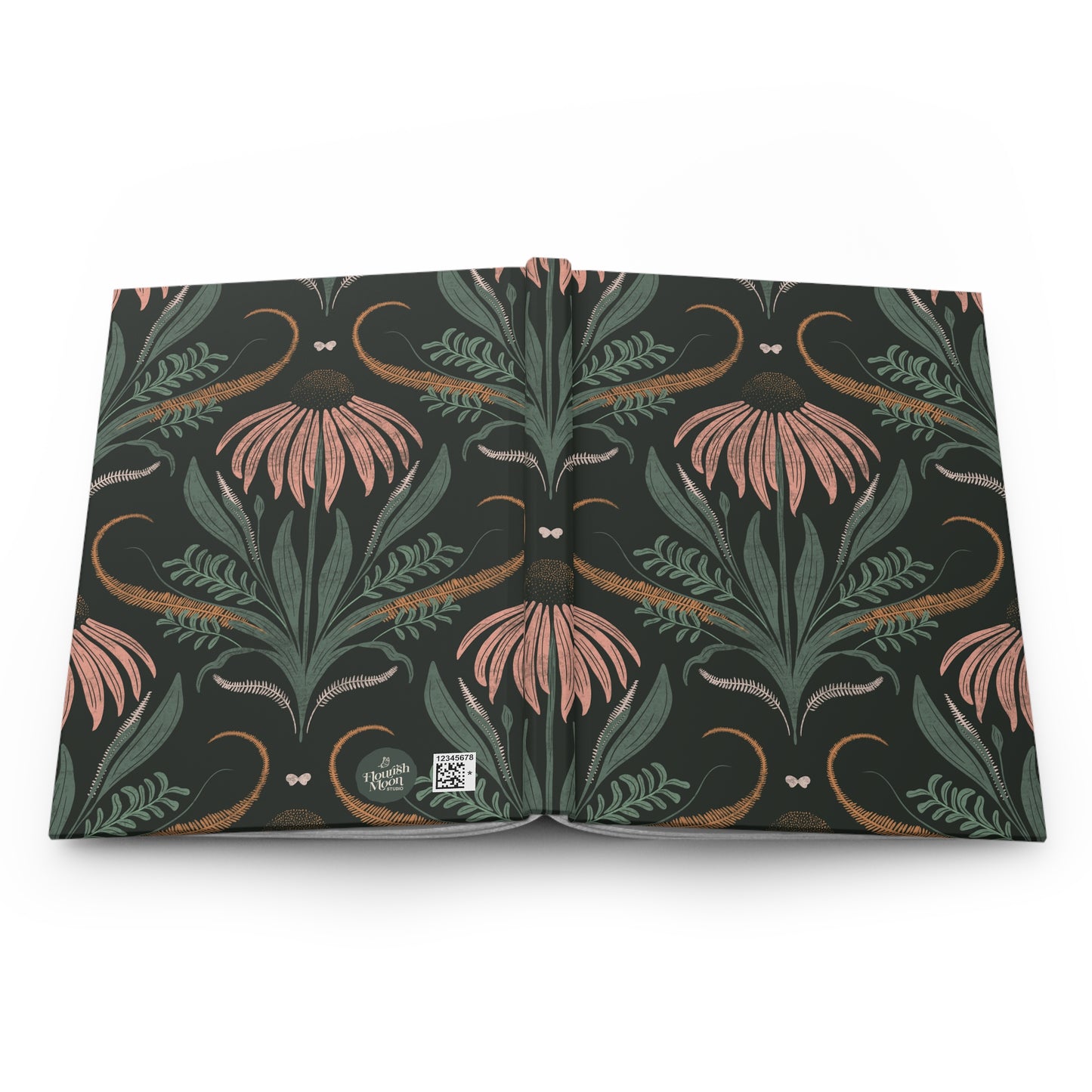 Floral journal open face down on a white counter.