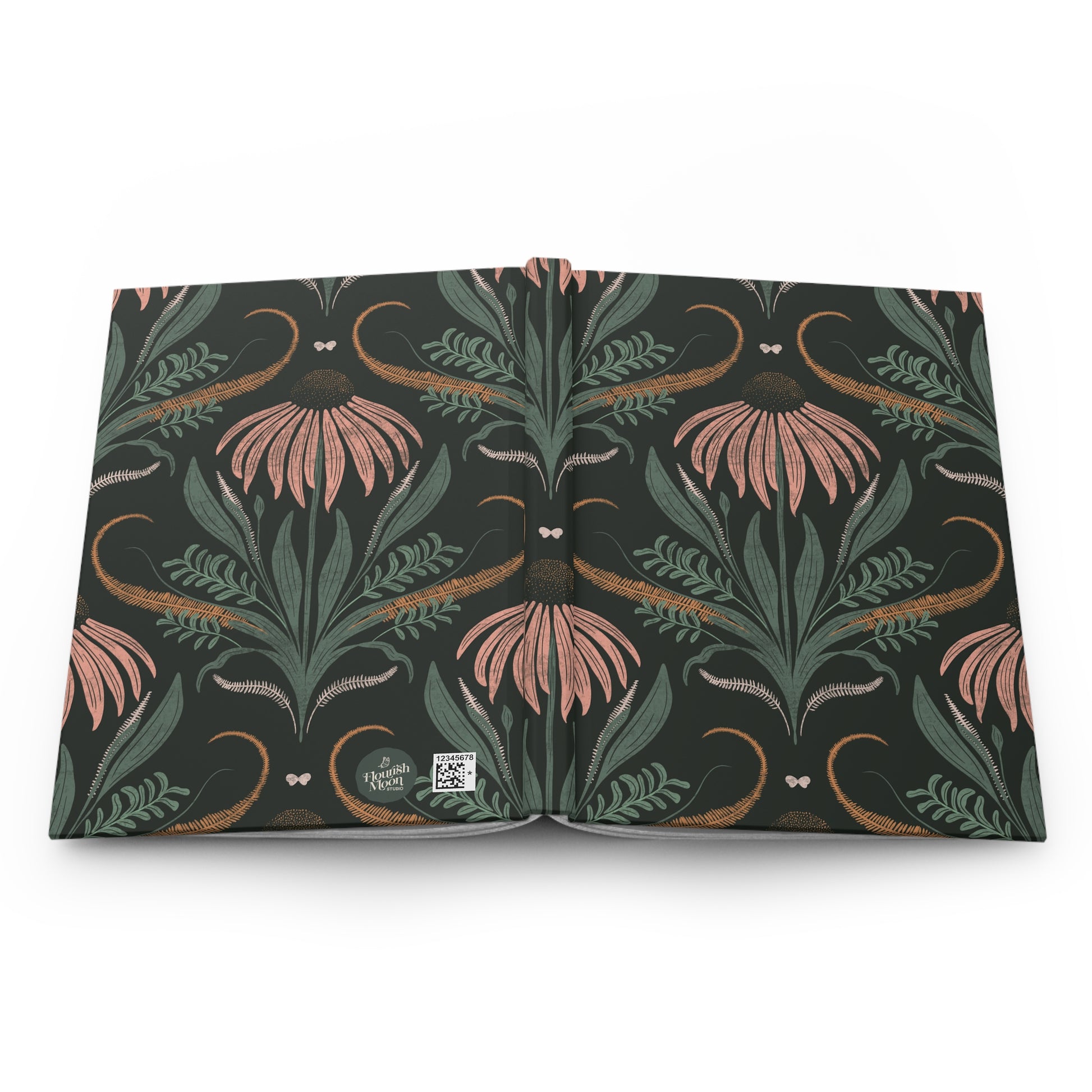 Floral journal open face down on a white counter.