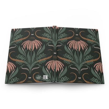 Floral journal open face down on a white counter.