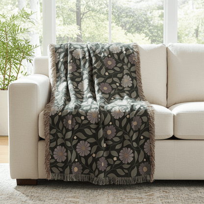 Floral patterned throw blanket draped over a beige sofa in a bright living room.